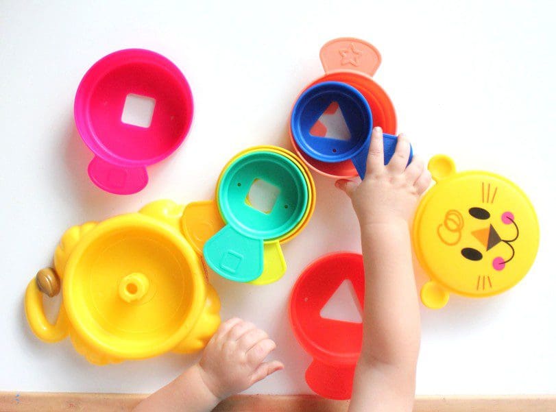 Toddler hands playign with toys