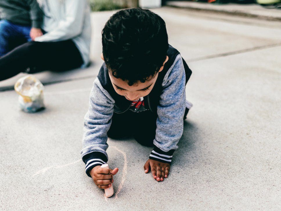 Child drawing with chalk