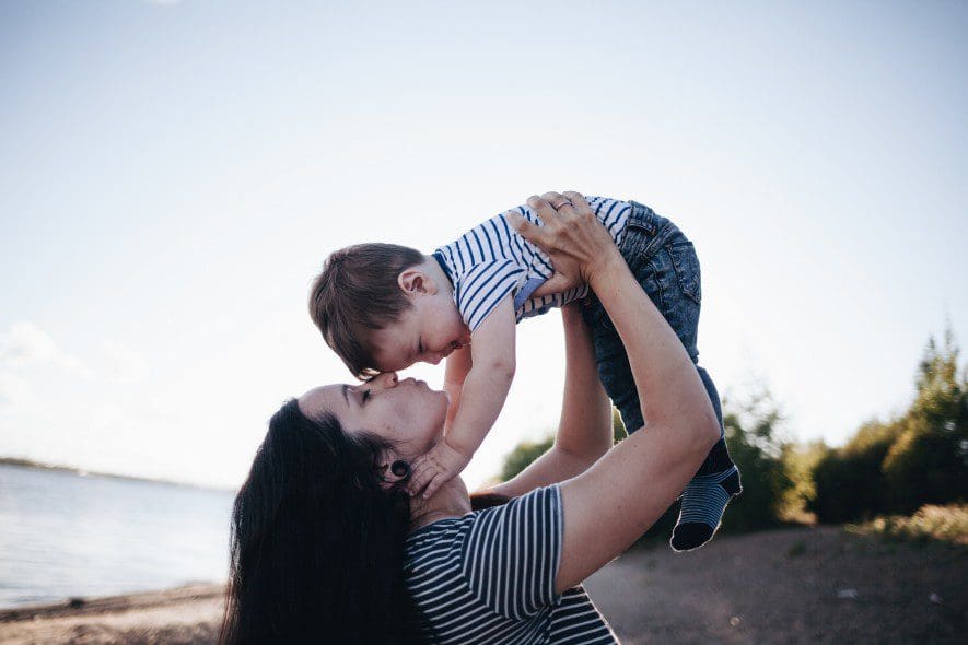 Mother smiling and holding child