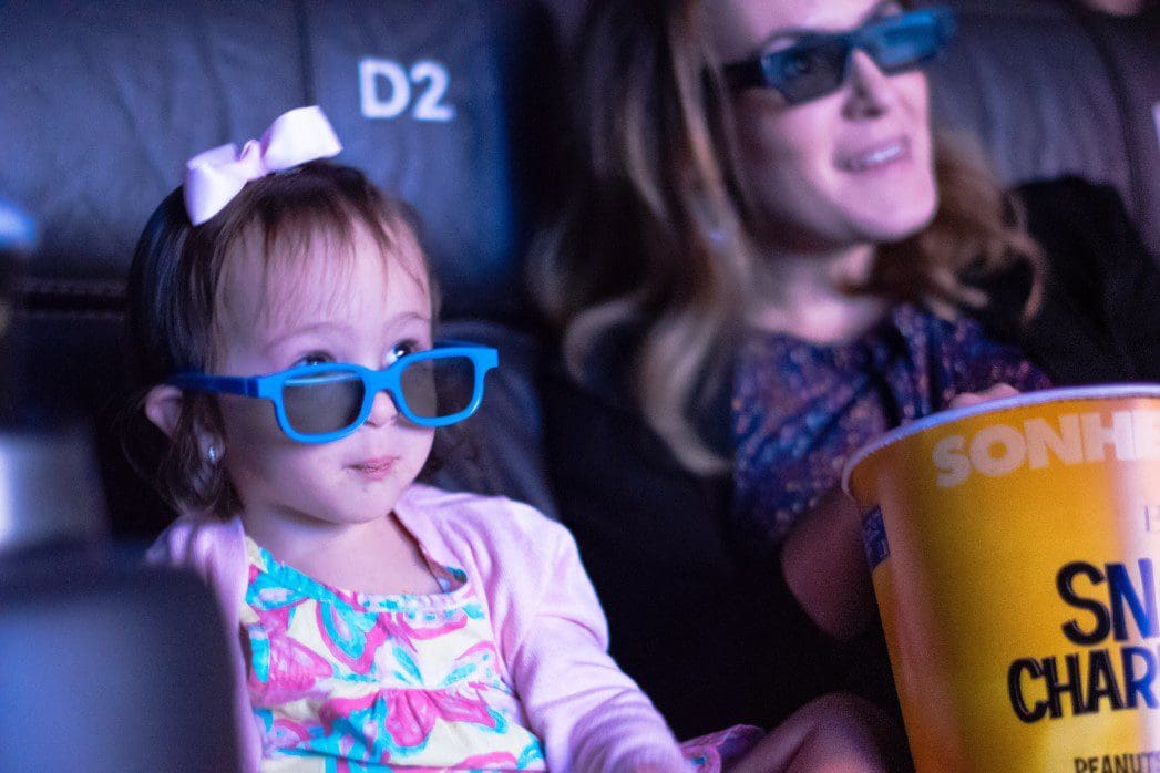 Adult and child at the movies
