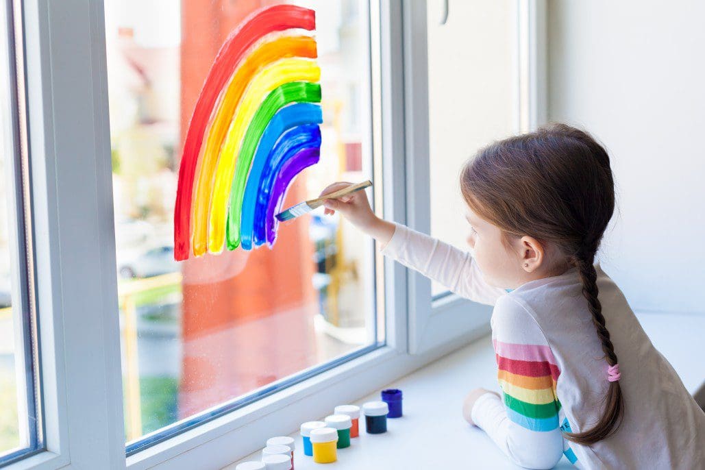 Child painting a rainbow