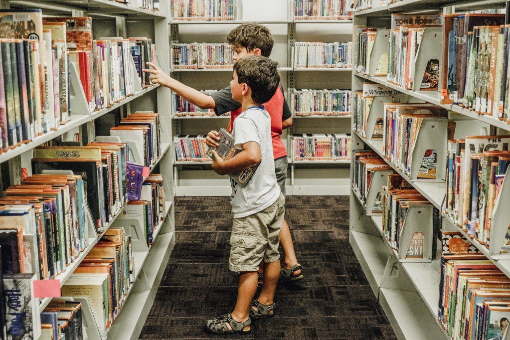 Kids choosing a book at the library