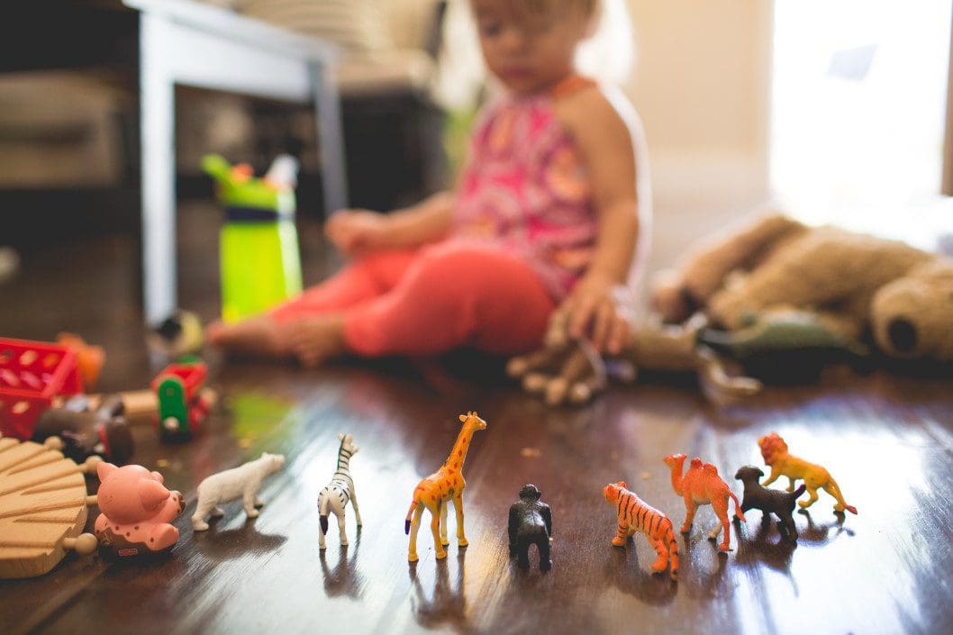 Child playing with animal figures
