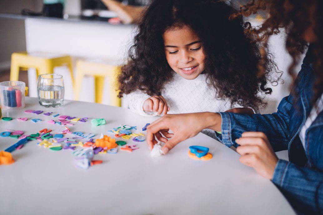 learning-playing-child-table-family-mother-creative-together-happy-toy_t20_Xzww83 Adult and child playing