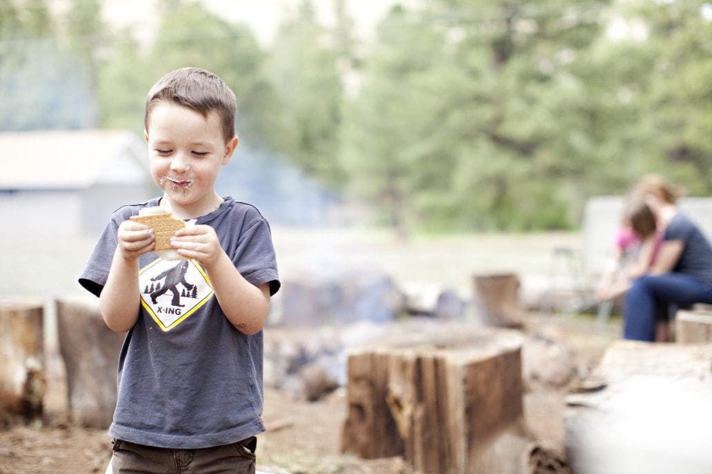Child eating a smore at summer camp