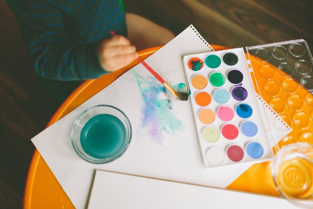 Child painting with watercolors