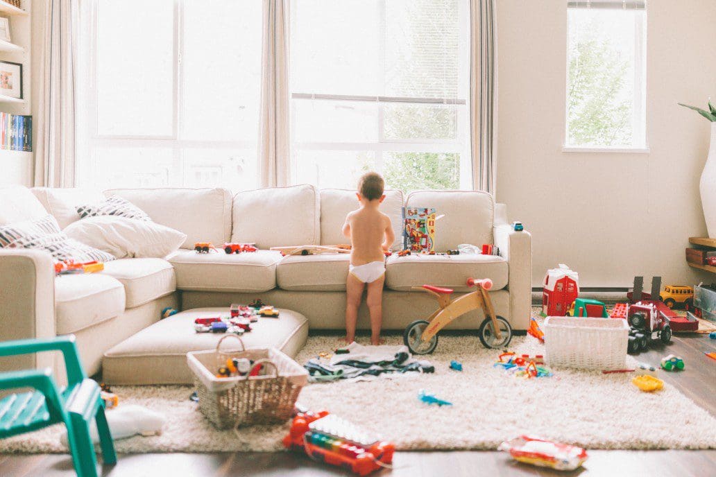 Child surrounded by toys playing