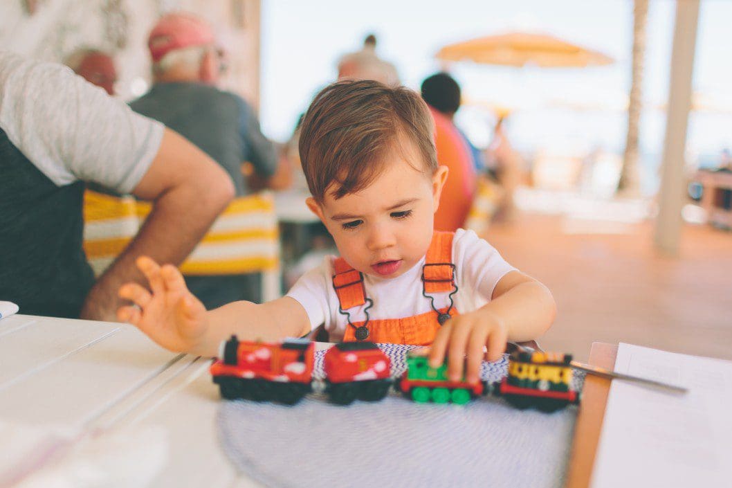 Child playing with toy train