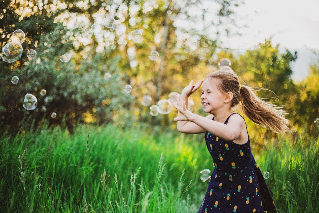 Girl chasing bubbles