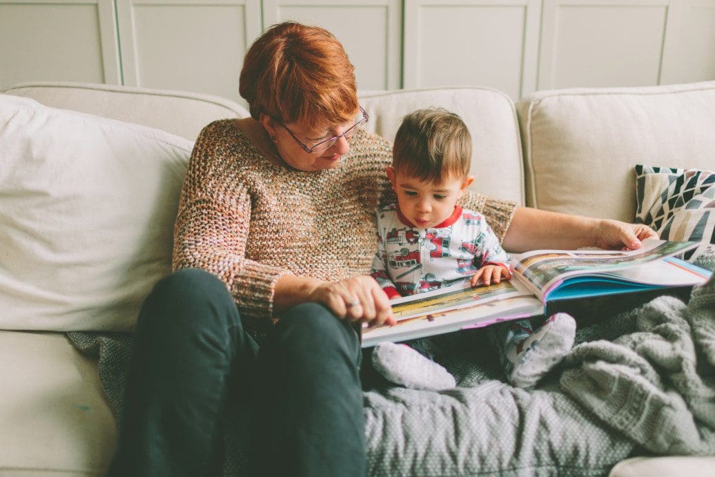 Child and adult reading together to promote language learning.