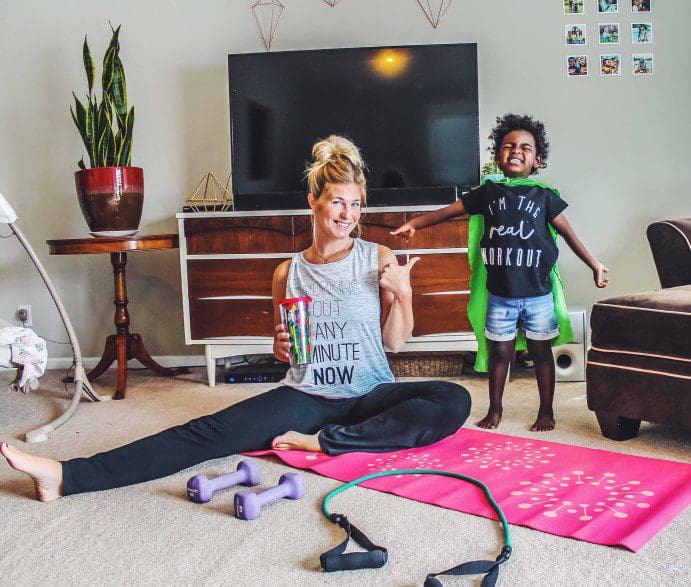 family-workout Mother working out with child near by.