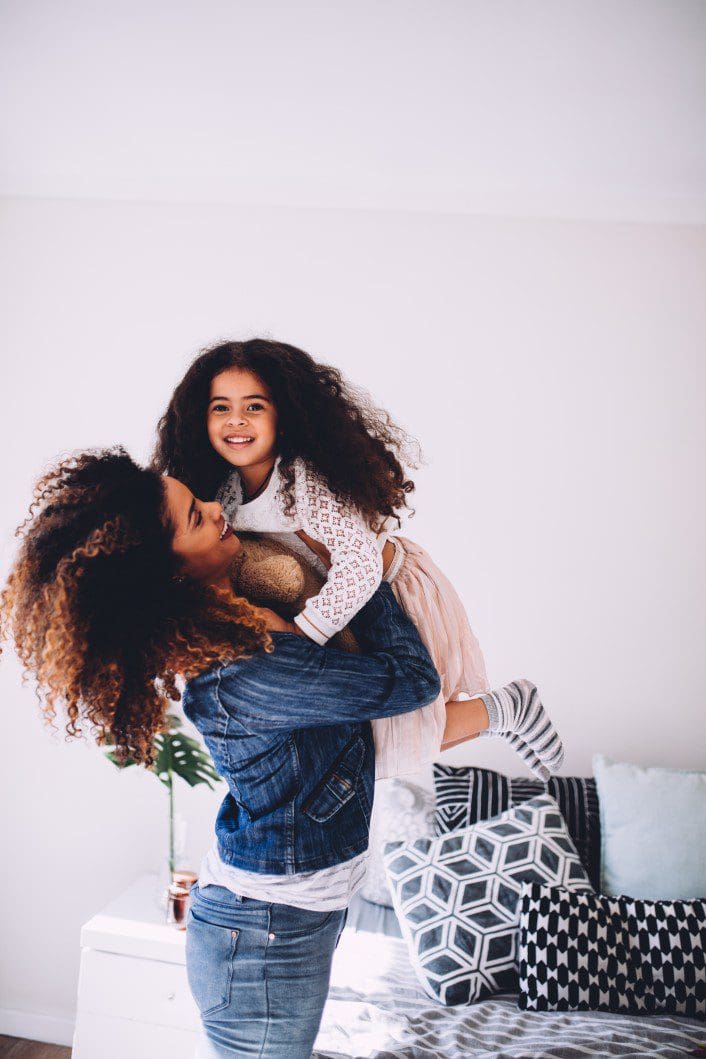 Mother holding child as positive reinforcement.