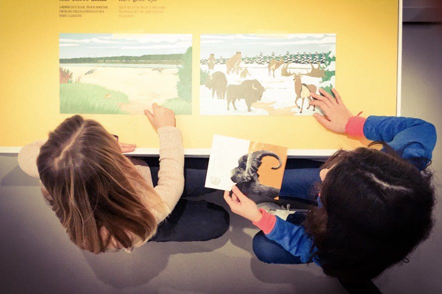 little-girls-having-fun-at-the-museum-with-games-on-prehistory-nominated-topview-top-view-space_t20_vL8B1E