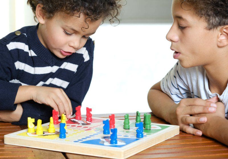 Young children playing a chess-like board game